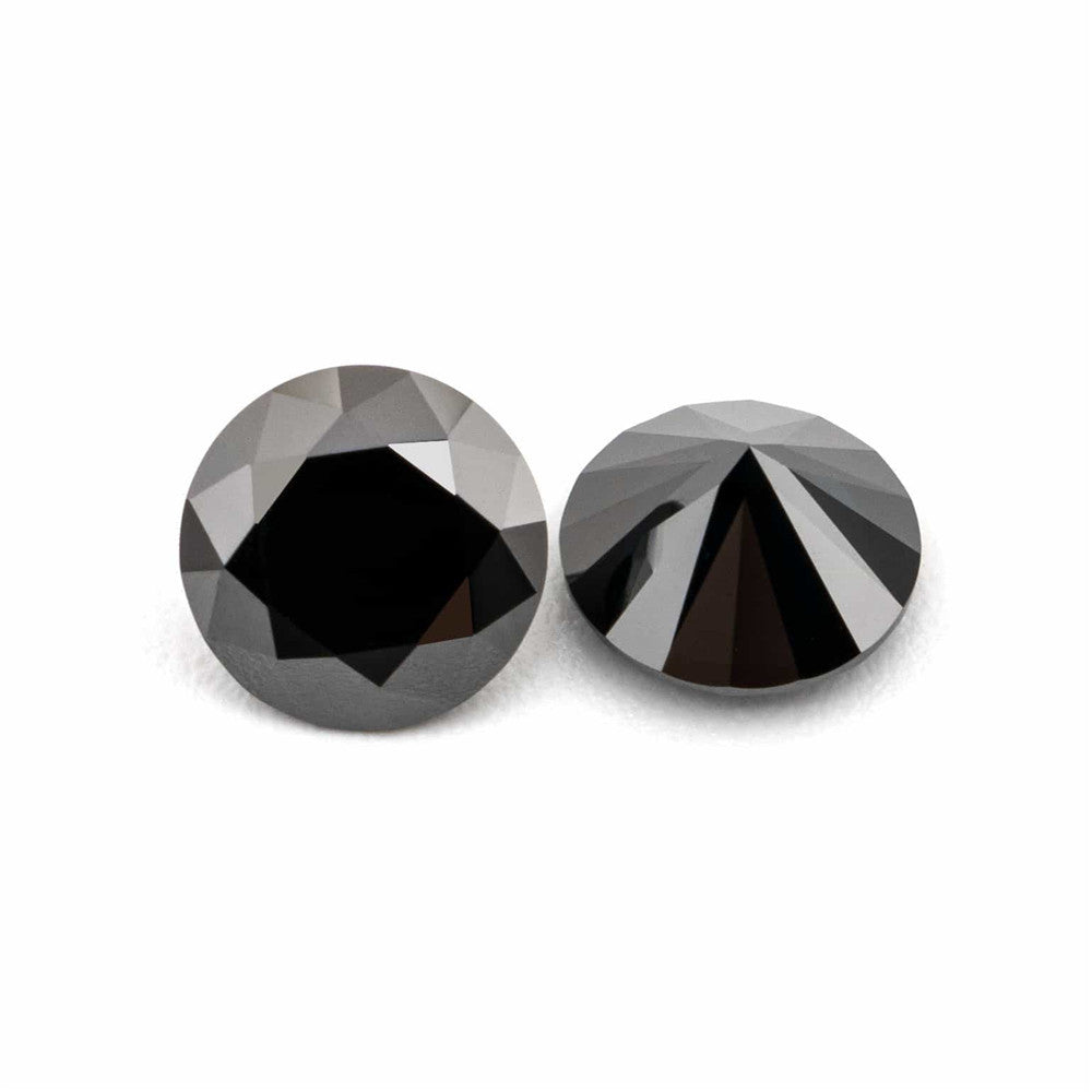 Two black gemstones on a white background