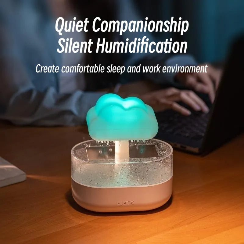 Humidifier with cloud design on a desk, person using laptop in the background