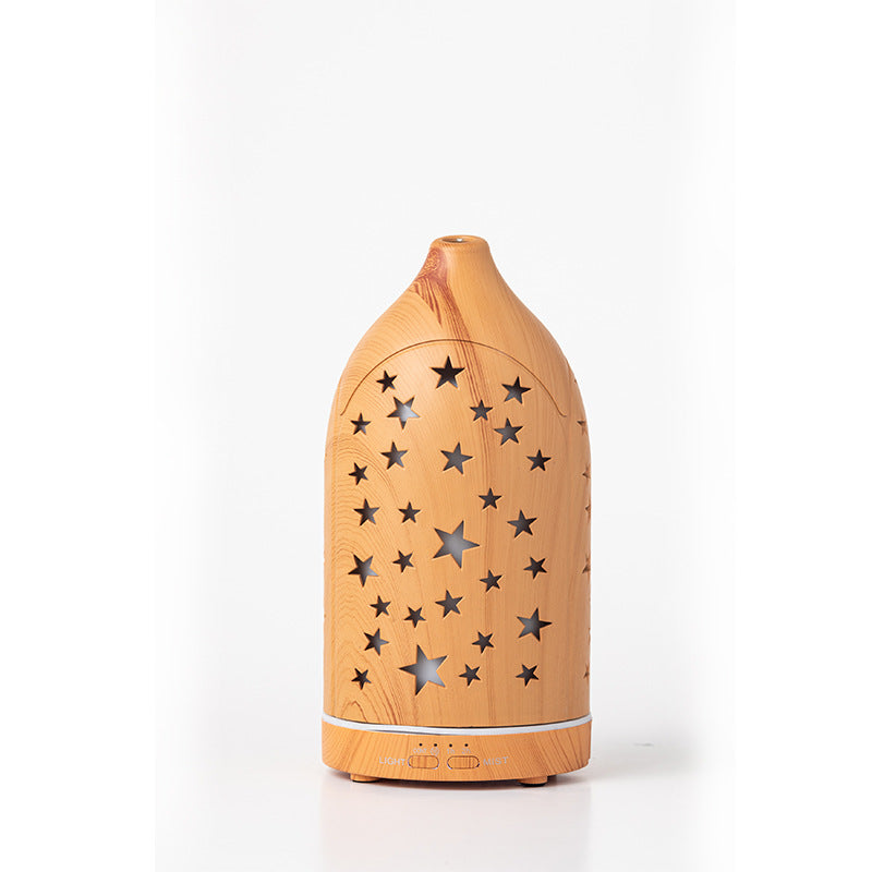 Wooden diffuser with star patterns on a white background