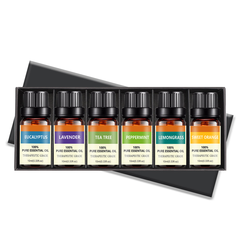 Set of six essential oil bottles in a black box with colorful labels.