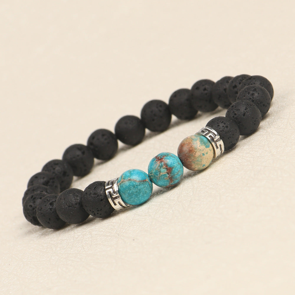 Bracelet with black lava beads and turquoise stones on a beige background