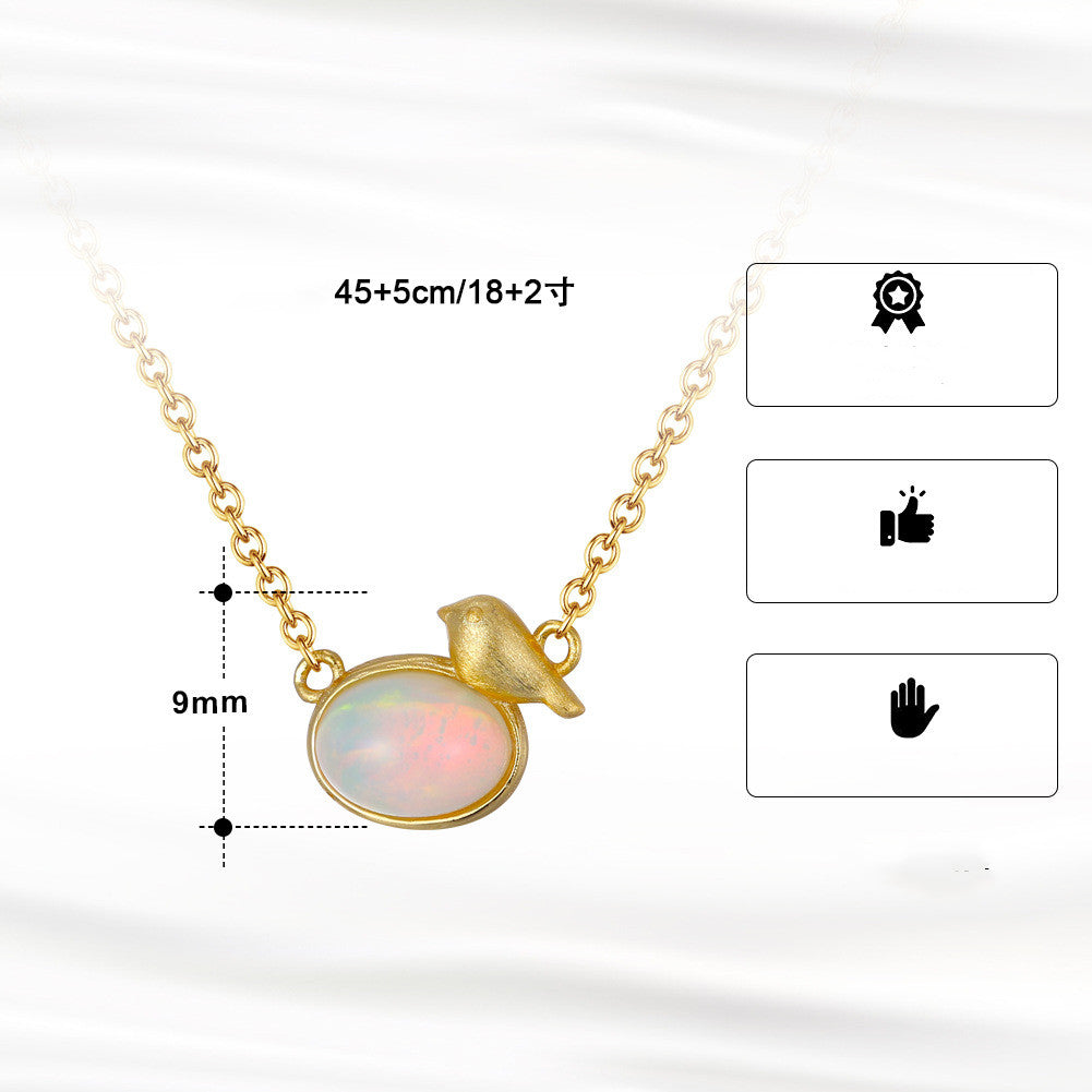 Gold necklace with a circular pendant on a white background