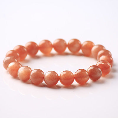 Peach-colored beaded bracelet on a white background