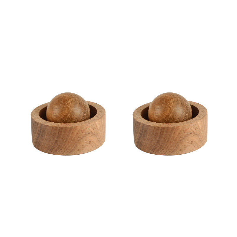 Two wooden bowls with spherical objects inside on a white background