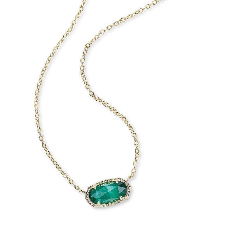 Gold necklace with a green gemstone pendant on a white background