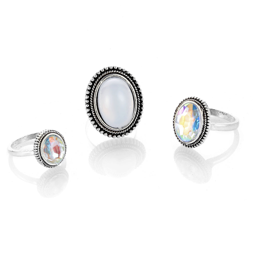 Three rings with gemstones on a white background