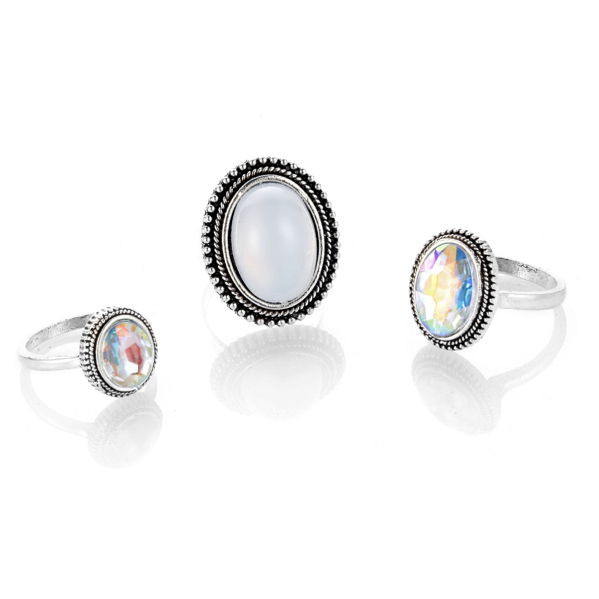 Three rings with gemstones on a white background