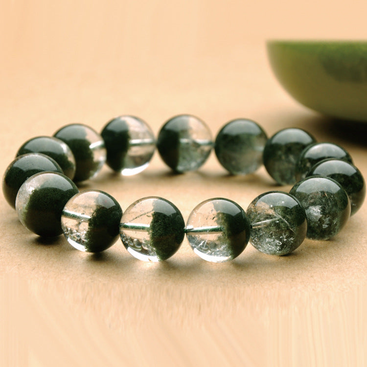 Green beaded bracelet on a beige surface
