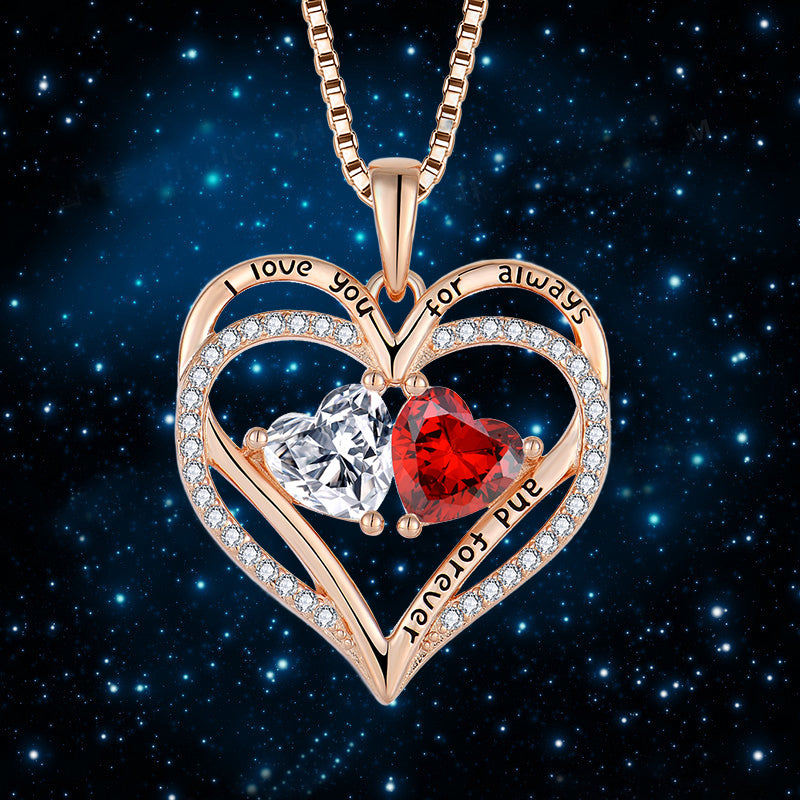 Heart-shaped pendant with red and clear gemstones on a dark starry background