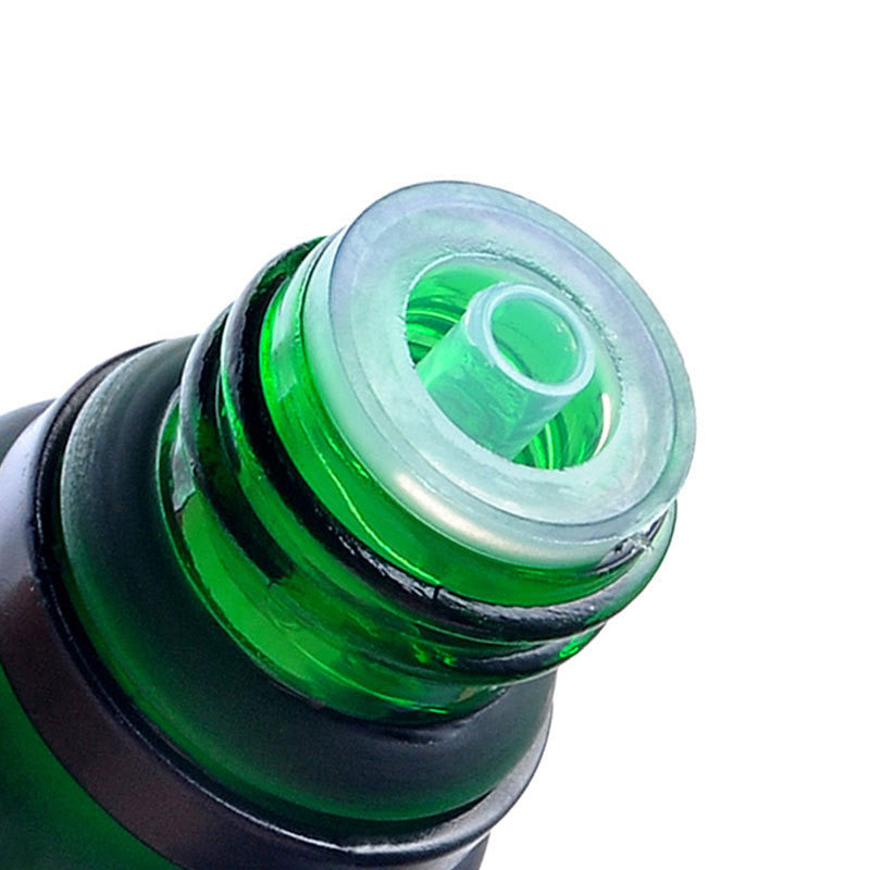 Close-up of a green bottle cap with a white interior on a white background