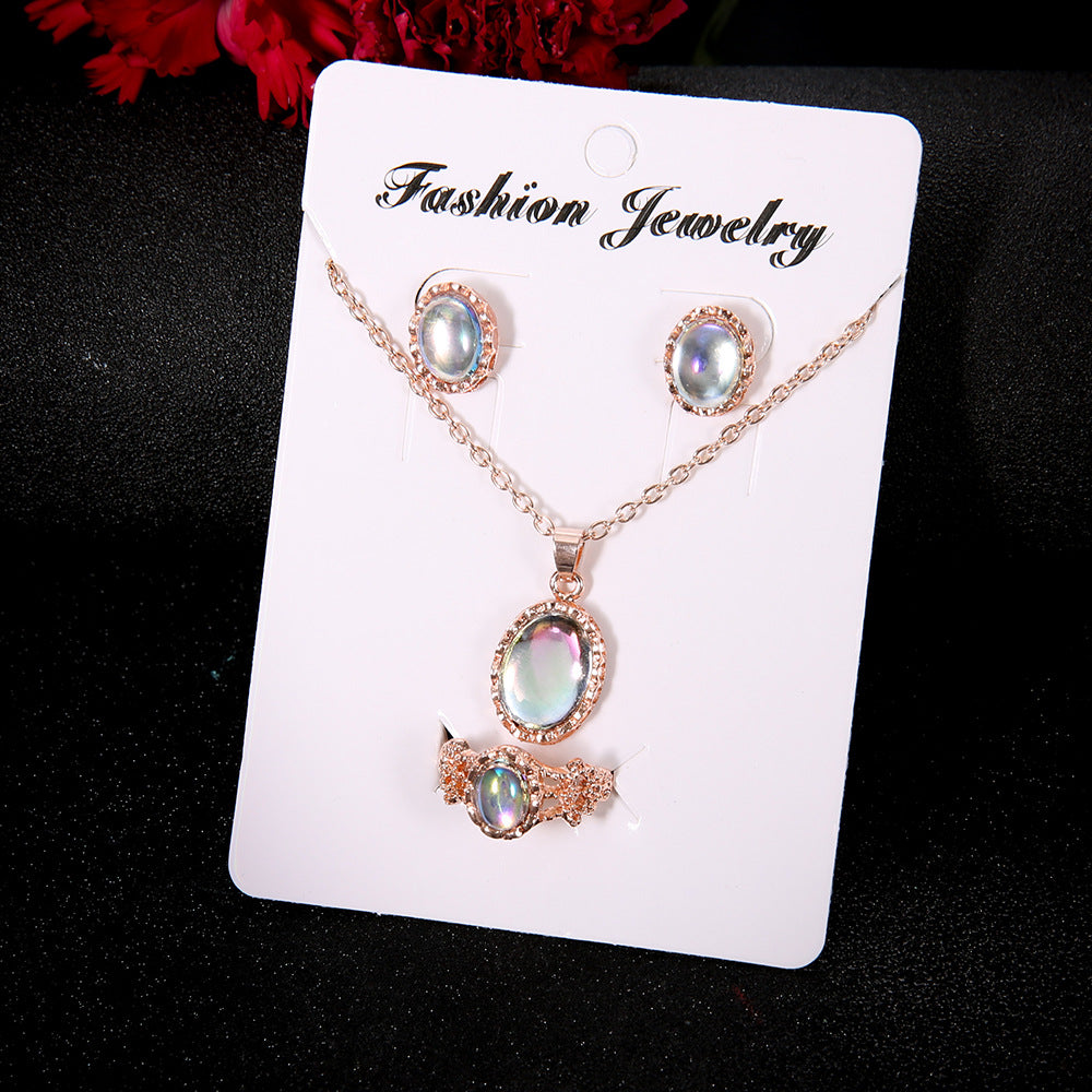 Jewelry set with necklace, earrings, and pendant on a 'Fashion Jewelry' card against a dark background.