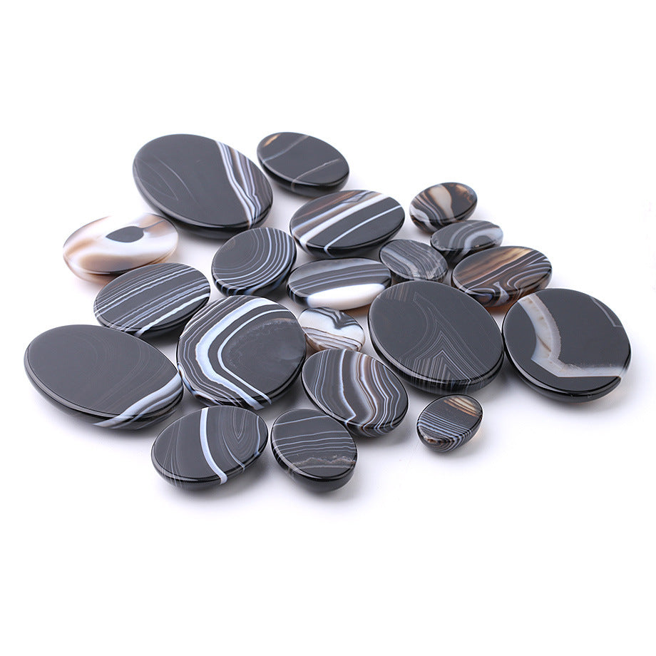 Collection of black and white marbled stones on a white background