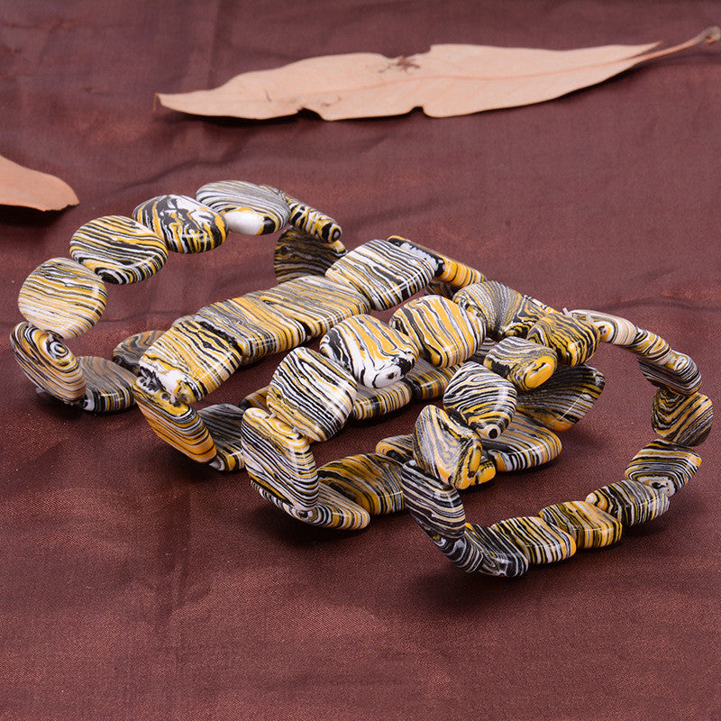 Decorative snake made of marbled material on a brown fabric background