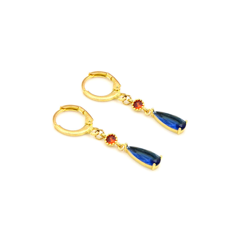 Gold hoop earrings with colorful teardrop-shaped stones on a white background
