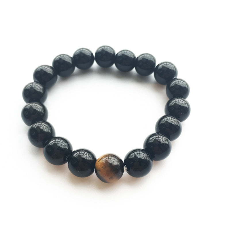 Black beaded bracelet with brown accents on a white background