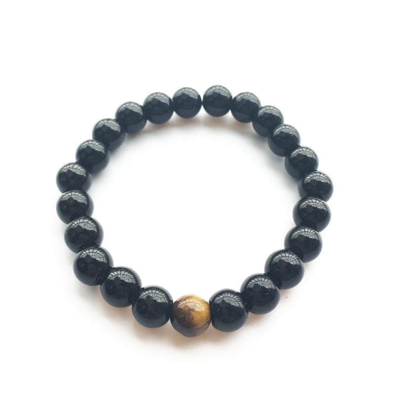 Black beaded bracelet with a single yellow tiger eye stone on a white background