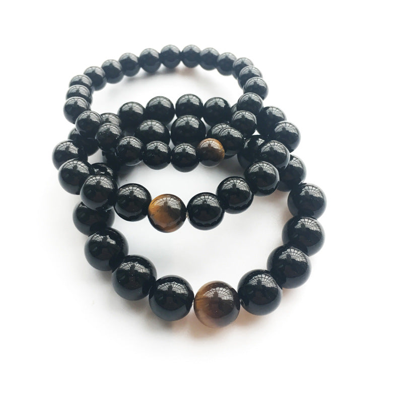 Black beaded bracelet with brown tiger eye stones on a white background