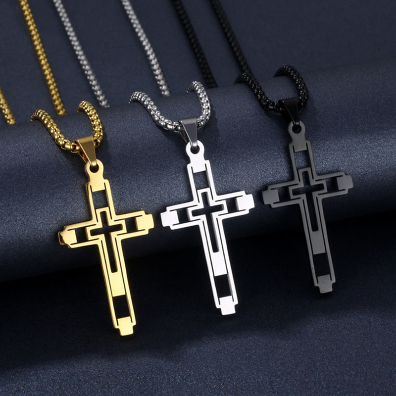 Three cross necklaces in gold, silver, and black on a dark fabric background