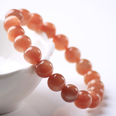 Orange beaded bracelet on a white background