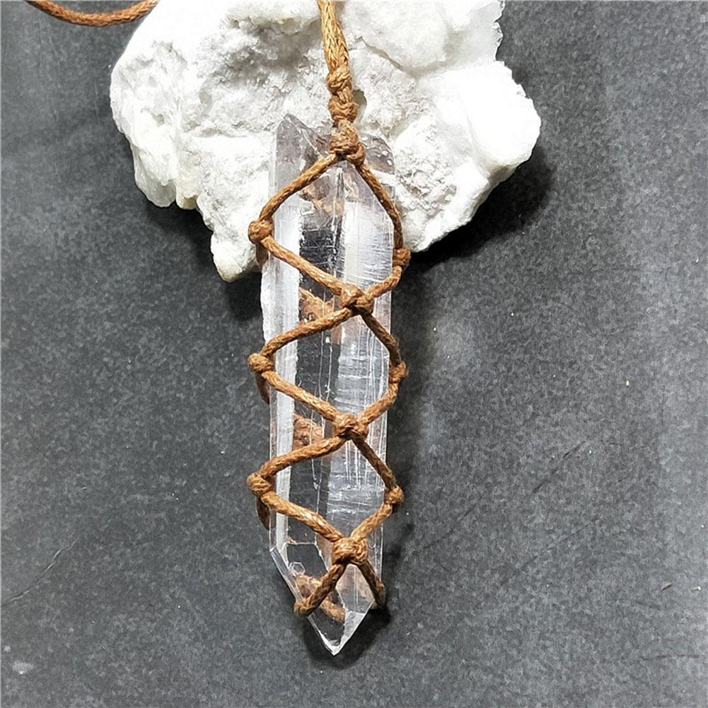 Crystal point with woven brown cord against a gray background