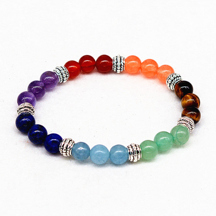 Multicolored beaded bracelet with silver beads on a white background