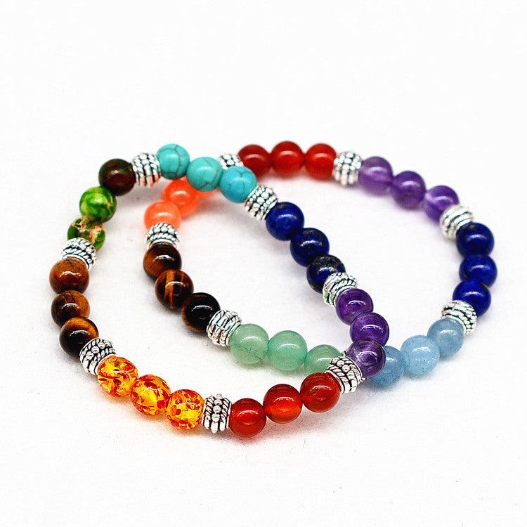 Set of four beaded bracelets in various colors on a white background