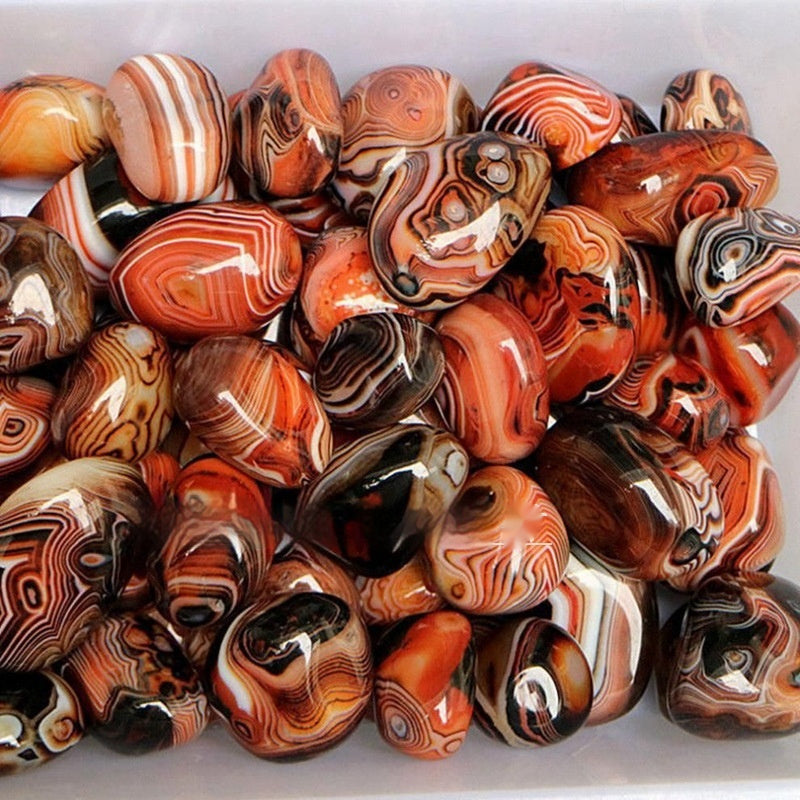 Collection of marbled stones with orange, brown, and white patterns.