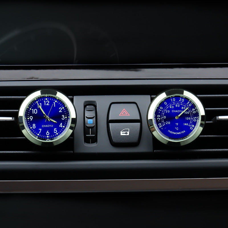Car dashboard with clock and thermometer on air vent