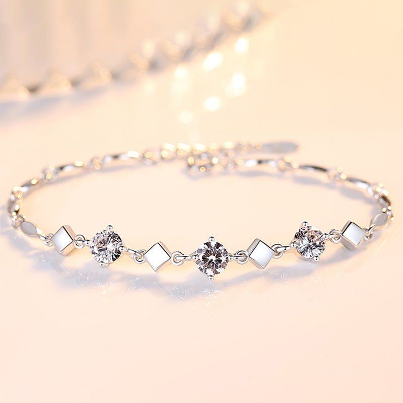 Silver bracelet with diamond-like stones on a soft background