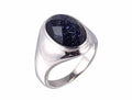 Silver ring with a blue gemstone on a white background