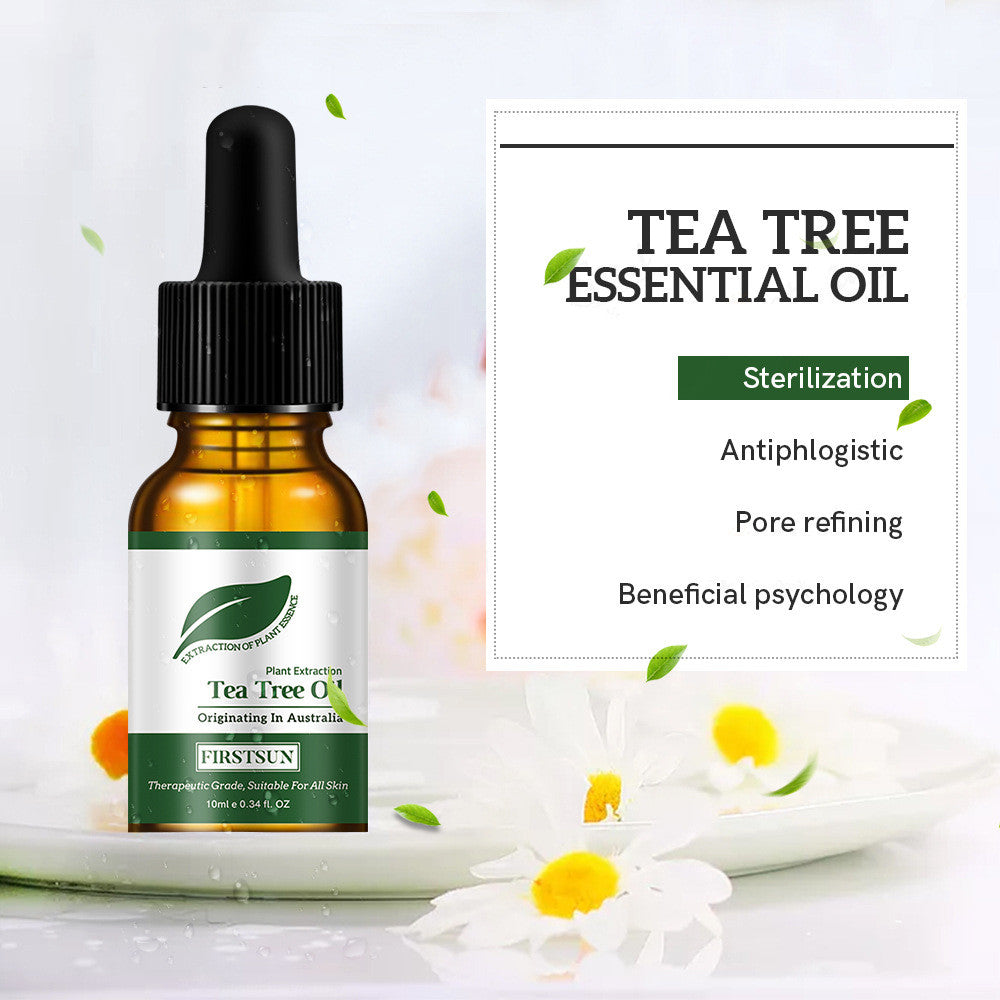 Tea tree essential oil bottle with dropper and label on a light background with flowers.