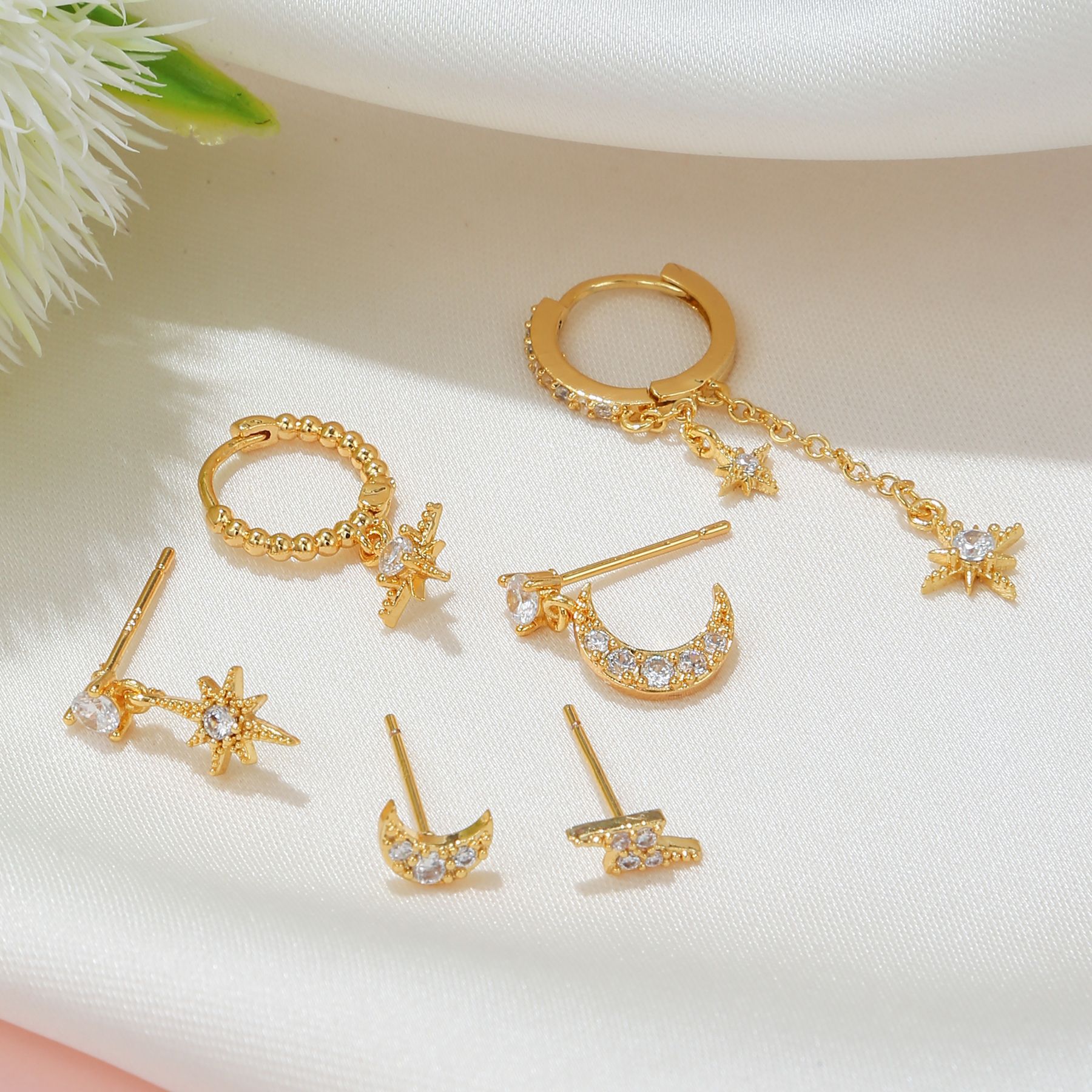 Set of gold earrings on a light background