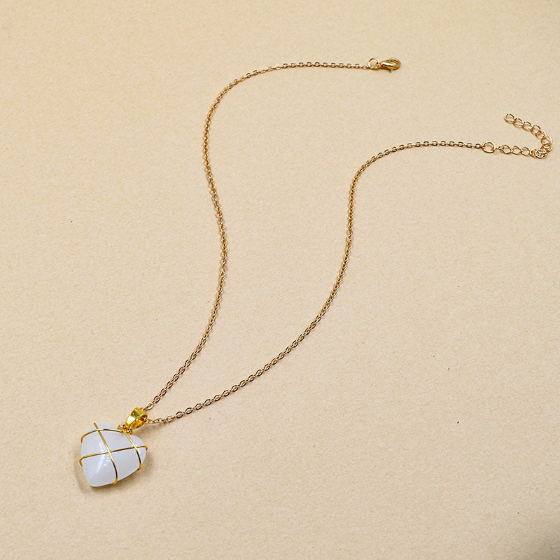 Necklace with a heart-shaped pendant on a beige background