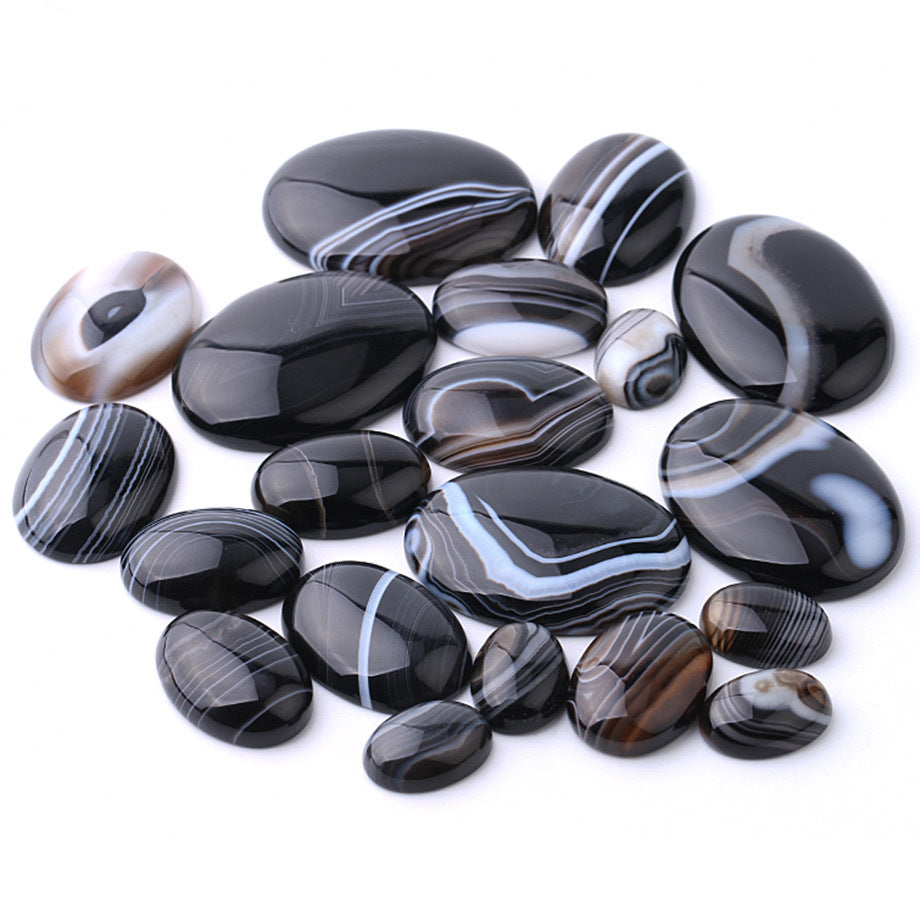 Collection of black and white marbled stones on a white background