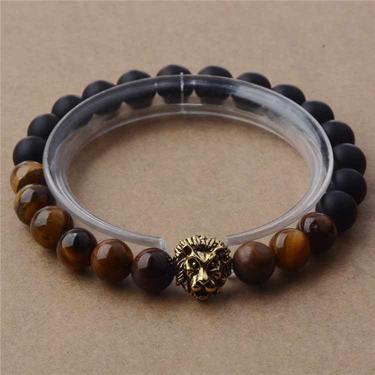Bracelet with lion head charm on a beige background