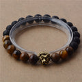 Bracelet with lion head charm on a beige background