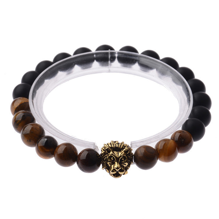 Black and brown beaded bracelet with a gold lion head charm on a white background