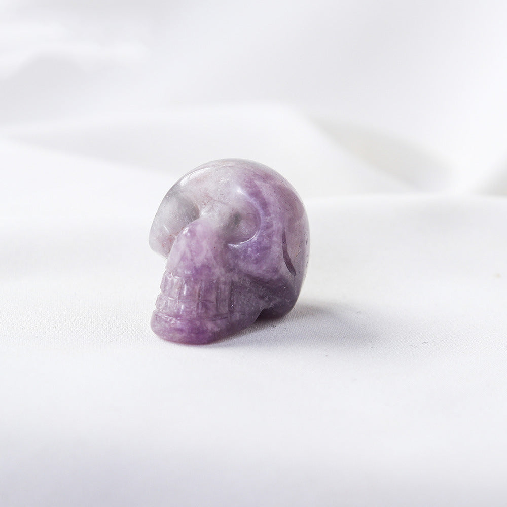 Purple crystal skull on a white background