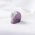 Purple crystal skull on a white background