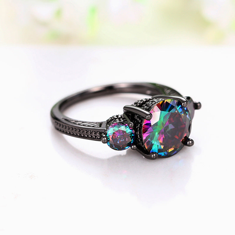 Ring with a multicolored gemstone on a white background