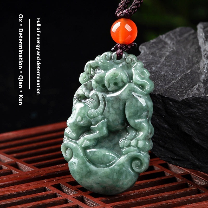 Green jade pendant with red stone on a dark background
