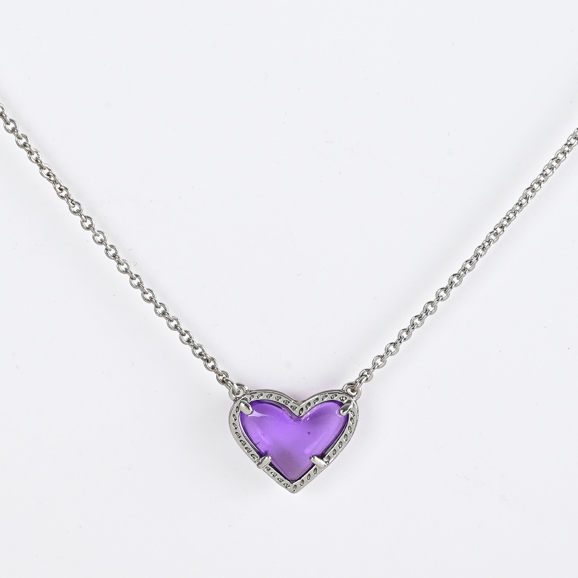 Necklace with a purple heart-shaped pendant on a white background