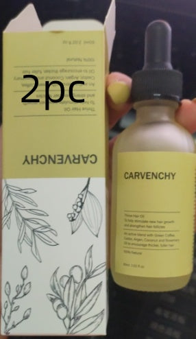 Carvenchy hair oil bottle and box with a hand holding the bottle.