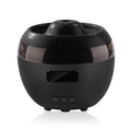 Black ceramic pot with cracked texture on a white background