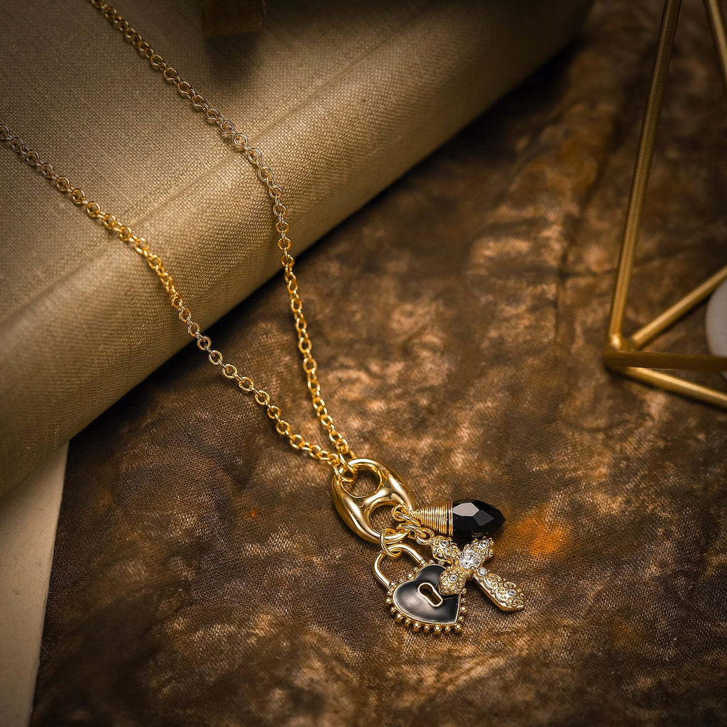 Gold necklace with charms on a textured surface