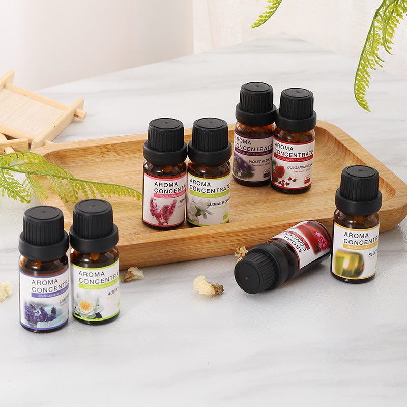 Collection of Aroma Concentra essential oil bottles on a wooden tray with a white background.