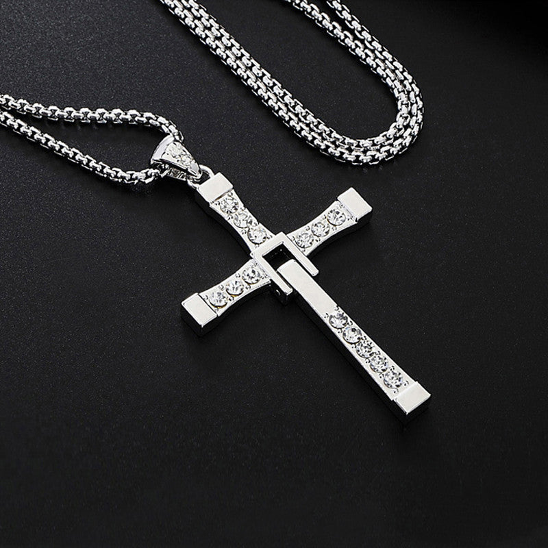Silver cross pendant necklace on a black background