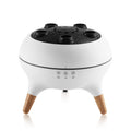 White electronic device with wooden legs and black top on a white background