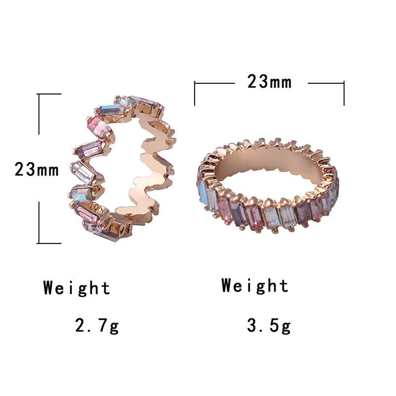 Two rings with colorful gemstones and measurements on a white background