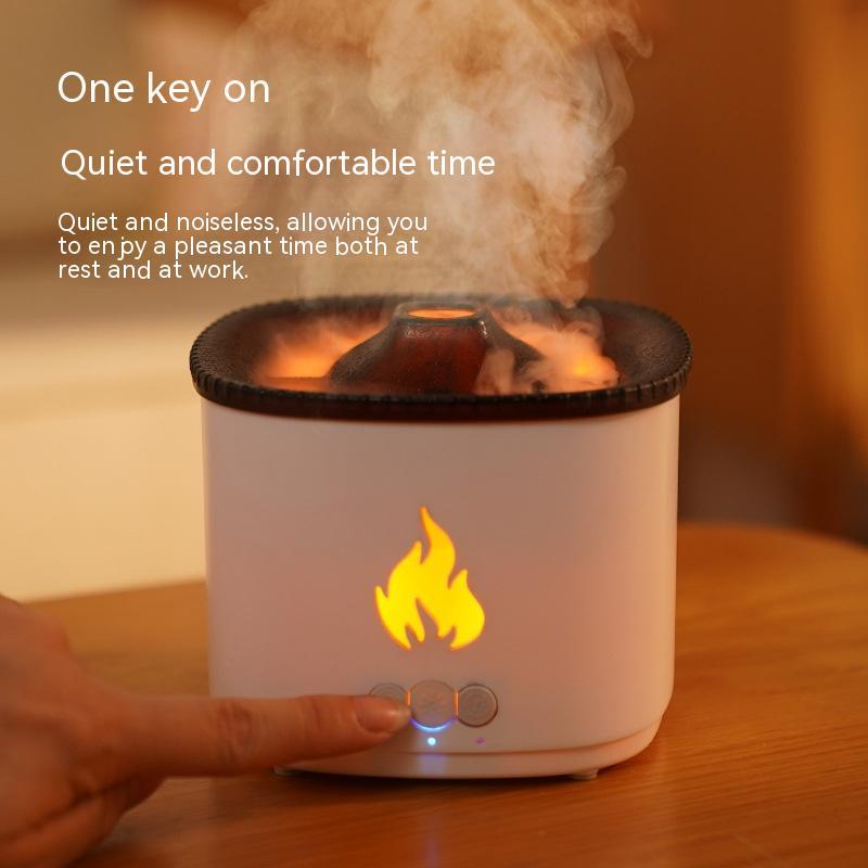 White diffuser with flame design on a wooden surface, emitting steam.